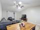 Bright living room featuring a large sectional sofa, media console, and a dining area with a wooden table at 1803 Foxhall Cir # 1803, Kissimmee, FL 34741