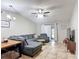 Comfortable living room featuring a large sectional sofa, ceiling fan, and sliding glass doors at 1803 Foxhall Cir # 1803, Kissimmee, FL 34741