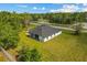 Aerial view of the home featuring a modern roof, covered patio, and spacious yard, surrounded by lush greenery at 19073 Sabal St, Orlando, FL 32833