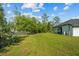 Lush backyard features a covered patio and privacy fence, offering a serene and private outdoor space at 19073 Sabal St, Orlando, FL 32833