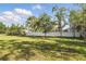 A large, fenced backyard with mature trees offering privacy and plenty of space for recreation at 19073 Sabal St, Orlando, FL 32833