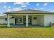 Backyard view of home's covered patio, windows and an air conditioning unit at 19073 Sabal St, Orlando, FL 32833
