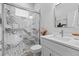 Bathroom with a white vanity, toilet, modern shower with glass door, and gray/white tile at 19073 Sabal St, Orlando, FL 32833