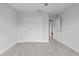 This bedroom boasts plush grey carpeting, a ceiling fan and a double door closet at 19073 Sabal St, Orlando, FL 32833