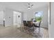 A bright dining area showcases a modern ceiling fan and a gray accent rug under the wooden table set at 19073 Sabal St, Orlando, FL 32833