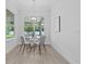 Cozy dining room with modern table, four chairs, pendant lighting, and view to backyard at 19073 Sabal St, Orlando, FL 32833