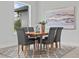 Dining room with wood table, gray chairs, geometric rug, and modern art piece creating a sophisticated dining experience at 19073 Sabal St, Orlando, FL 32833