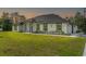 A modern single-story home, complemented by well-manicured lawn, neutral stucco exterior, and an attached garage at 19073 Sabal St, Orlando, FL 32833