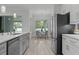 Modern kitchen with stainless steel appliances, gray cabinets, and view into the dining room at 19073 Sabal St, Orlando, FL 32833