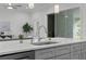 Close up of kitchen island with stainless steel sink and faucet, quartz countertop, and gray cabinets at 19073 Sabal St, Orlando, FL 32833