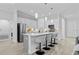 Bright kitchen featuring stainless steel appliances, large island with seating, and open layout at 19073 Sabal St, Orlando, FL 32833