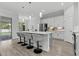 Stylish kitchen with stainless steel appliances, island with bar stools, and modern pendant lighting at 19073 Sabal St, Orlando, FL 32833