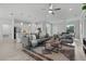 Open concept living room showcases a modern kitchen, neutral decor, stylish furniture, and tile flooring at 19073 Sabal St, Orlando, FL 32833