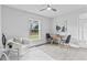 Comfortable living room setup with seating, a ceiling fan, and natural light from a large window at 19073 Sabal St, Orlando, FL 32833
