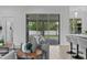 Open living room with hardwood floors, sliding glass doors and bar seating in background at 19073 Sabal St, Orlando, FL 32833