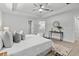 Bright main bedroom featuring a ceiling fan, ensuite bathroom, walk-in closet, and stylish decor at 19073 Sabal St, Orlando, FL 32833