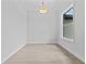 Clean and bright office space featuring wood-look floors, natural light from a large window, and modern light fixture at 19073 Sabal St, Orlando, FL 32833