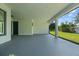 Covered patio with concrete floor and pillars; backyard with green grass and trees at 19073 Sabal St, Orlando, FL 32833