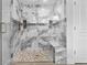 Elegant walk-in shower with marble-like tiles, a built-in bench, and a rain shower head at 19073 Sabal St, Orlando, FL 32833