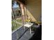 Cozy screened balcony with two chairs, a table, and stylish black tiled floors at 1950 Summer Club Dr # 202, Oviedo, FL 32765