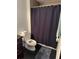 Cozy bathroom featuring a shower stall with a dark blue curtain, toilet, and dark flooring at 1950 Summer Club Dr # 202, Oviedo, FL 32765