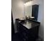 Bathroom vanity with a dark stone countertop, vessel sink and a large mirror at 1950 Summer Club Dr # 202, Oviedo, FL 32765