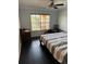 Bedroom with black tile flooring, neutral walls, and a large window at 1950 Summer Club Dr # 202, Oviedo, FL 32765