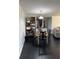 Cozy dining area featuring a round wooden table, modern shelving, and black tile flooring at 1950 Summer Club Dr # 202, Oviedo, FL 32765