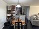 Cozy dining area featuring a round wooden table, modern shelving, and black tile flooring at 1950 Summer Club Dr # 202, Oviedo, FL 32765