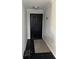 Clean, modern entryway featuring a black door and black tile flooring, with a neutral area rug at 1950 Summer Club Dr # 202, Oviedo, FL 32765