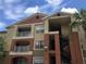 Well-maintained condo exterior with balconies, stairs, and lush landscaping, under a partly cloudy sky at 1950 Summer Club Dr # 202, Oviedo, FL 32765