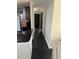 Hallway featuring black tiled flooring with black doors and leading to the kitchen with stainless steel appliances at 1950 Summer Club Dr # 202, Oviedo, FL 32765