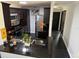 Kitchen featuring stainless steel appliances, dark brown cabinets and black countertops that provide ample counter space at 1950 Summer Club Dr # 202, Oviedo, FL 32765