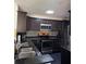 Kitchen showcasing dark cabinets, granite countertops, mosaic backsplash, and stainless steel appliances, providing a modern look at 1950 Summer Club Dr # 202, Oviedo, FL 32765