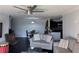 Living room featuring a ceiling fan, and an open floor plan, with black tile flooring, flowing into dining and kitchen at 1950 Summer Club Dr # 202, Oviedo, FL 32765