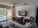 Comfortable living room with a ceiling fan, glass doors to a balcony, and modern furnishings at 1950 Summer Club Dr # 202, Oviedo, FL 32765