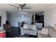 Living room featuring a ceiling fan, and an open floor plan, with black tile flooring, flowing into dining and kitchen at 1950 Summer Club Dr # 202, Oviedo, FL 32765