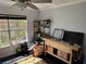 Bright room with black flooring, workbench with tools, shelves, and a window to the outside at 1950 Summer Club Dr # 202, Oviedo, FL 32765