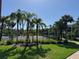 An inviting community tennis court is surrounded by lush, tropical landscaping and mature palm trees at 1950 Summer Club Dr # 202, Oviedo, FL 32765