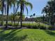 Enjoy a game on the community tennis court, with lush green landscaping and a glimpse of the pool beyond at 1950 Summer Club Dr # 202, Oviedo, FL 32765