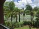 A meticulously maintained community tennis court offers an active lifestyle amidst tropical landscaping at 1950 Summer Club Dr # 202, Oviedo, FL 32765