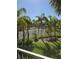 Scenic view of a tennis court, community pool, and lush greenery seen from a screened balcony at 1950 Summer Club Dr # 202, Oviedo, FL 32765