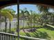 Beautiful screened balcony view overlooking lush greenery, palm trees, and a tennis court at 1950 Summer Club Dr # 202, Oviedo, FL 32765