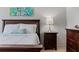 Cozy bedroom featuring a wooden bed frame, soft white bedding, and stylish nightstand with accent lamp at 200 Maitland Ave # 19, Altamonte Springs, FL 32701