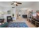 This open living room includes a ceiling fan, neutral walls, and a view to the dining area at 200 Maitland Ave # 19, Altamonte Springs, FL 32701
