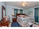 Bright bedroom with light blue walls, a comfortable bed, and cozy furnishings at 2304 N Hastings St, Orlando, FL 32808