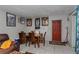 Dining area with a table set for four, adjacent to a red door, offering a cozy space at 2304 N Hastings St, Orlando, FL 32808