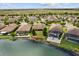 A stunning aerial view of a lakeside home with a lush green backyard and beautiful landscaping at 259 Blue Cypress Dr, Groveland, FL 34736
