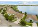 Stunning aerial view showcasing lakefront homes in a peaceful community with well-manicured lawns and landscaping at 259 Blue Cypress Dr, Groveland, FL 34736