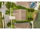 A bird's-eye view shows a single-Gathering house with a well-manicured lawn and verdant landscaping near a serene lake at 259 Blue Cypress Dr, Groveland, FL 34736